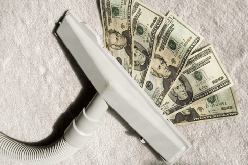 Attachment_to_vacuum_cleaner_sucking_up_five_$20_bills_on_sunlit_white_carpet.png