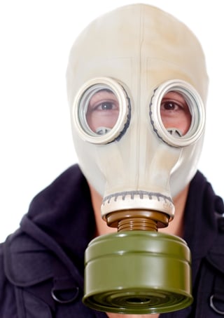 Man wearing a gas mask on his face - isolated over a white background.jpeg