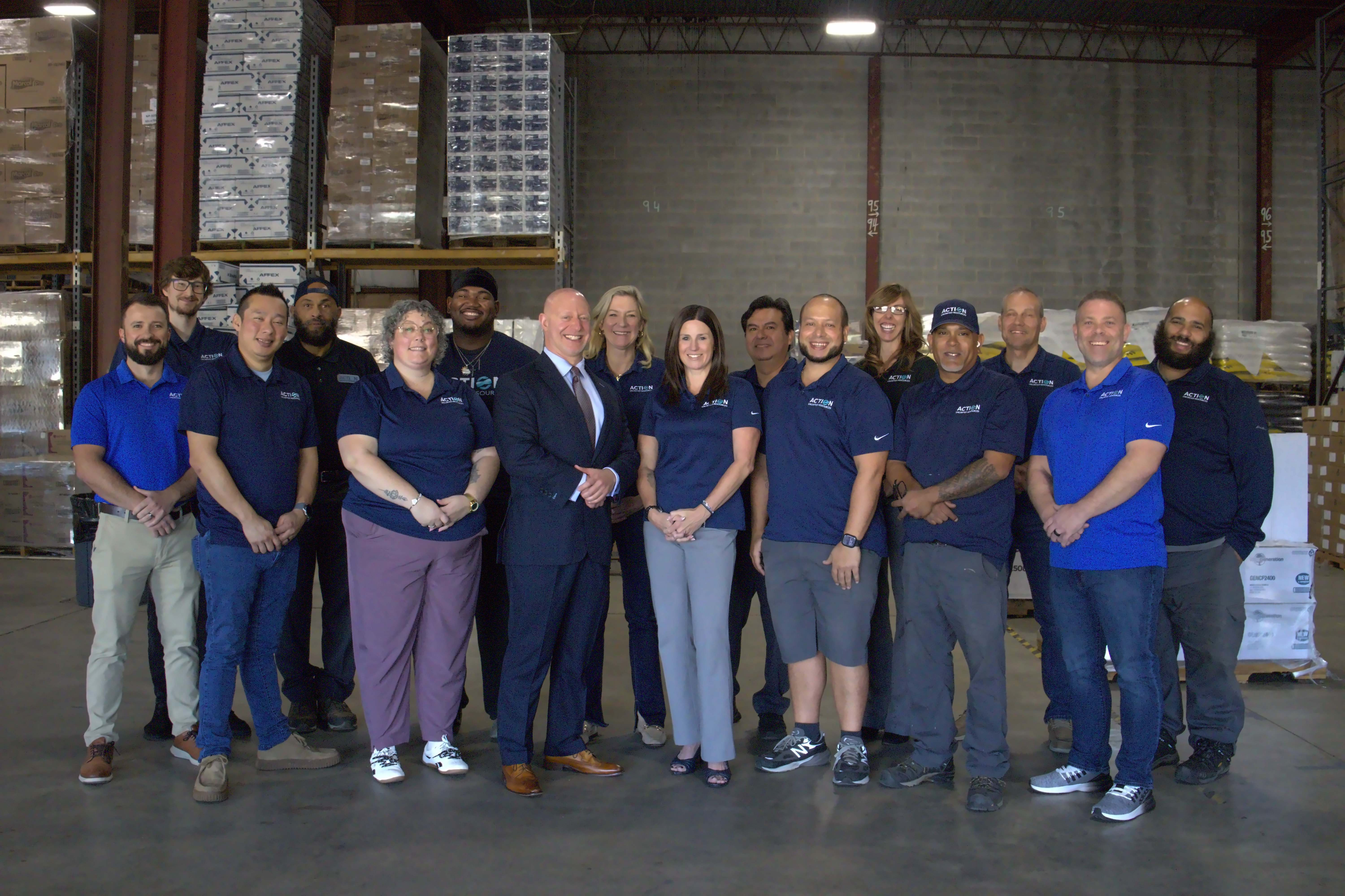 Action Unlimited Resources team together in the New Castle warehouse.